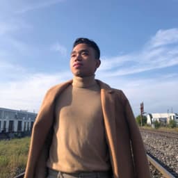 Author's profile picture wearing a formal turtle neck.